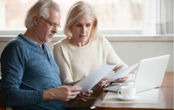 Worried senior couple calculating bills to pay and if they will need to declare bankruptcy