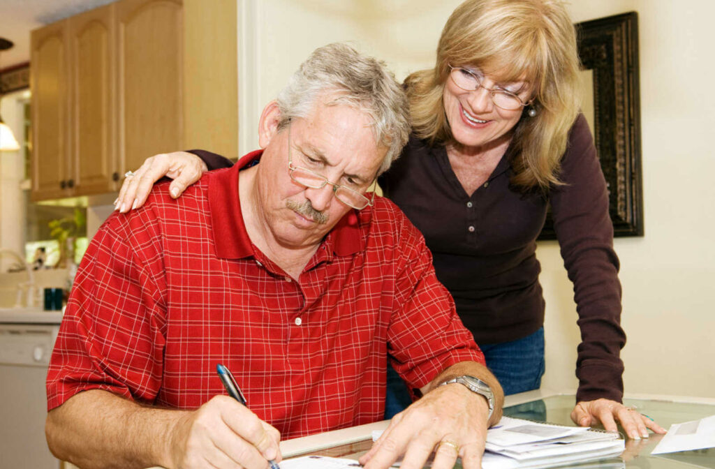 Wife supporting husband in bankruptcy process while signing papers