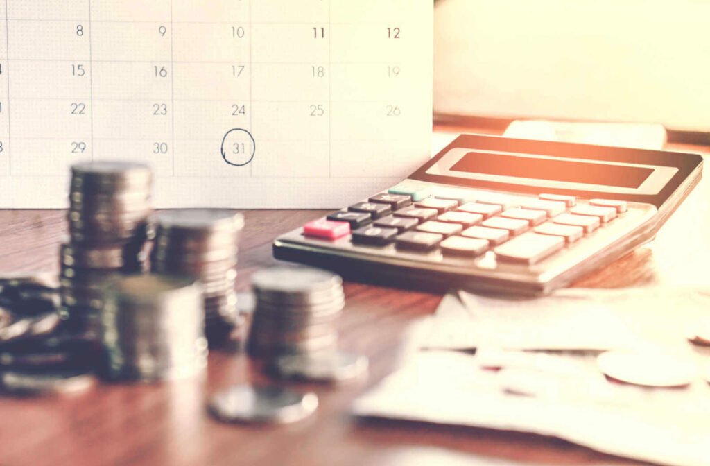 Money displayed with calculator and calendar in background to show loan due date