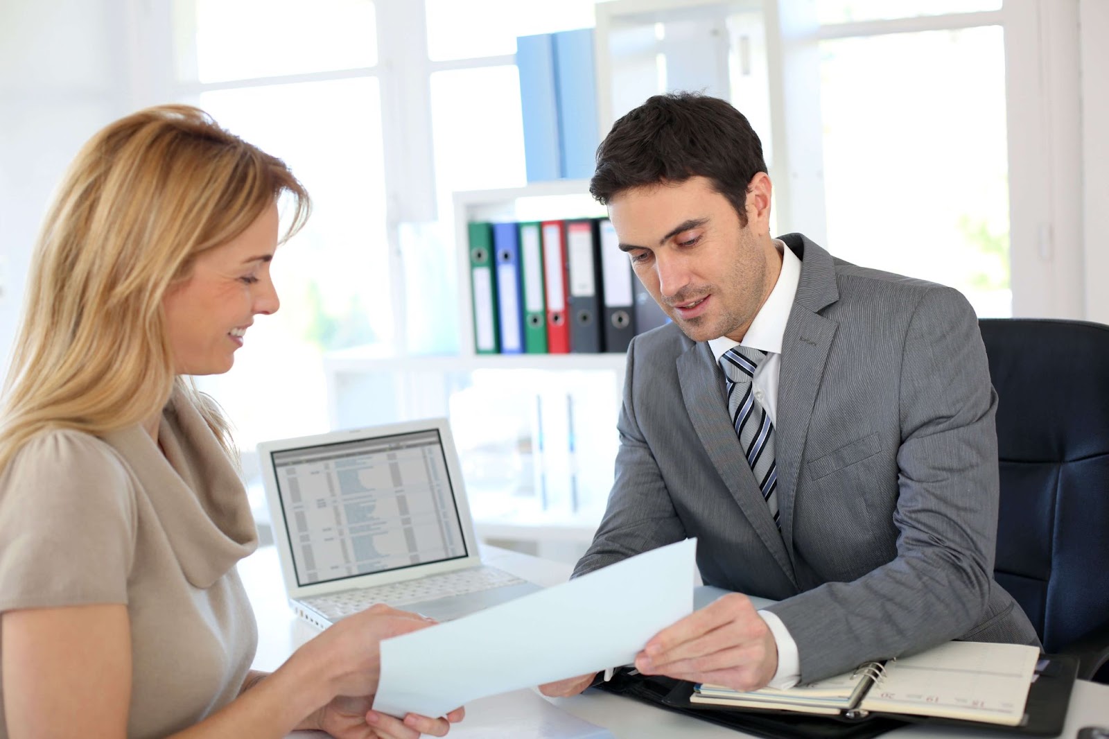 A Licensed Insolvency Trustee in his office a female client is consulting about bankruptcy