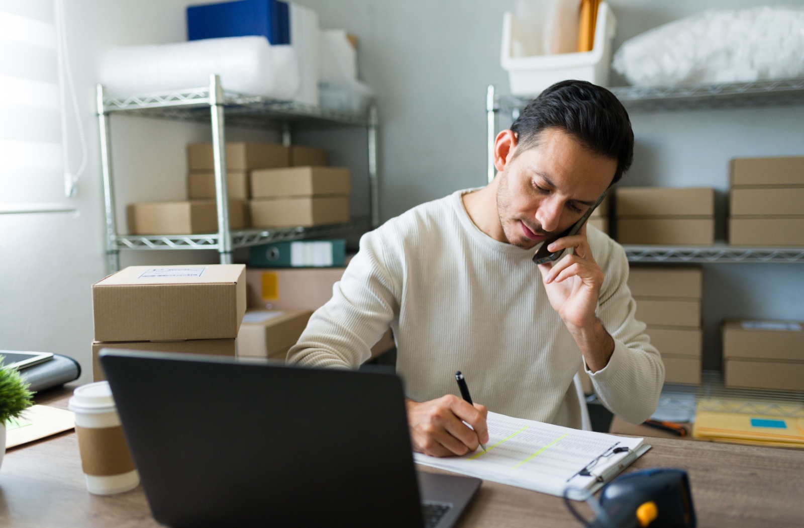 A small business owner on the phone, reviewing their financial statements.
