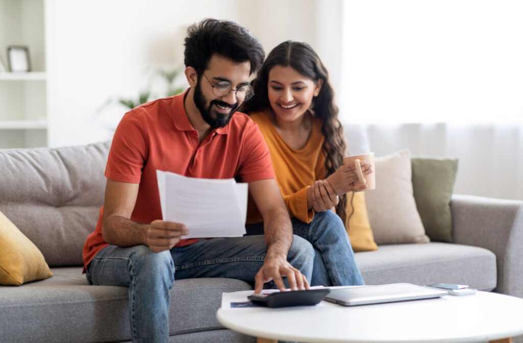 A relaxed couple works together to build their family budget.