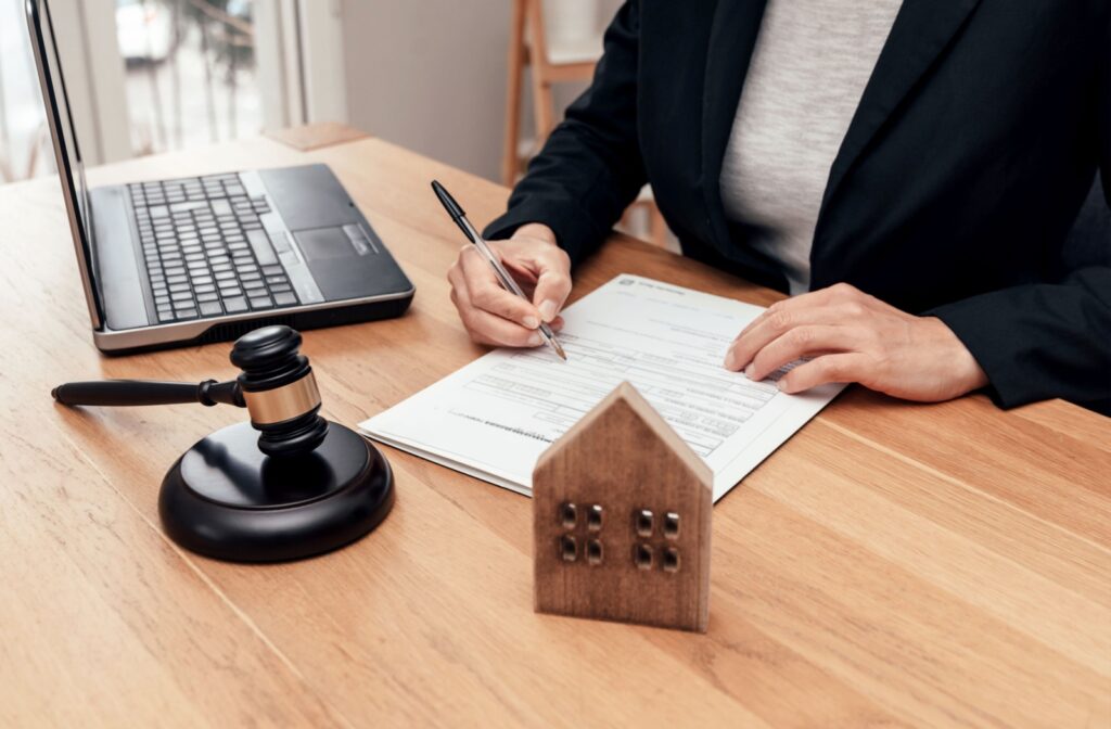 A person sitting at a desk filling out a foreclosure notice.