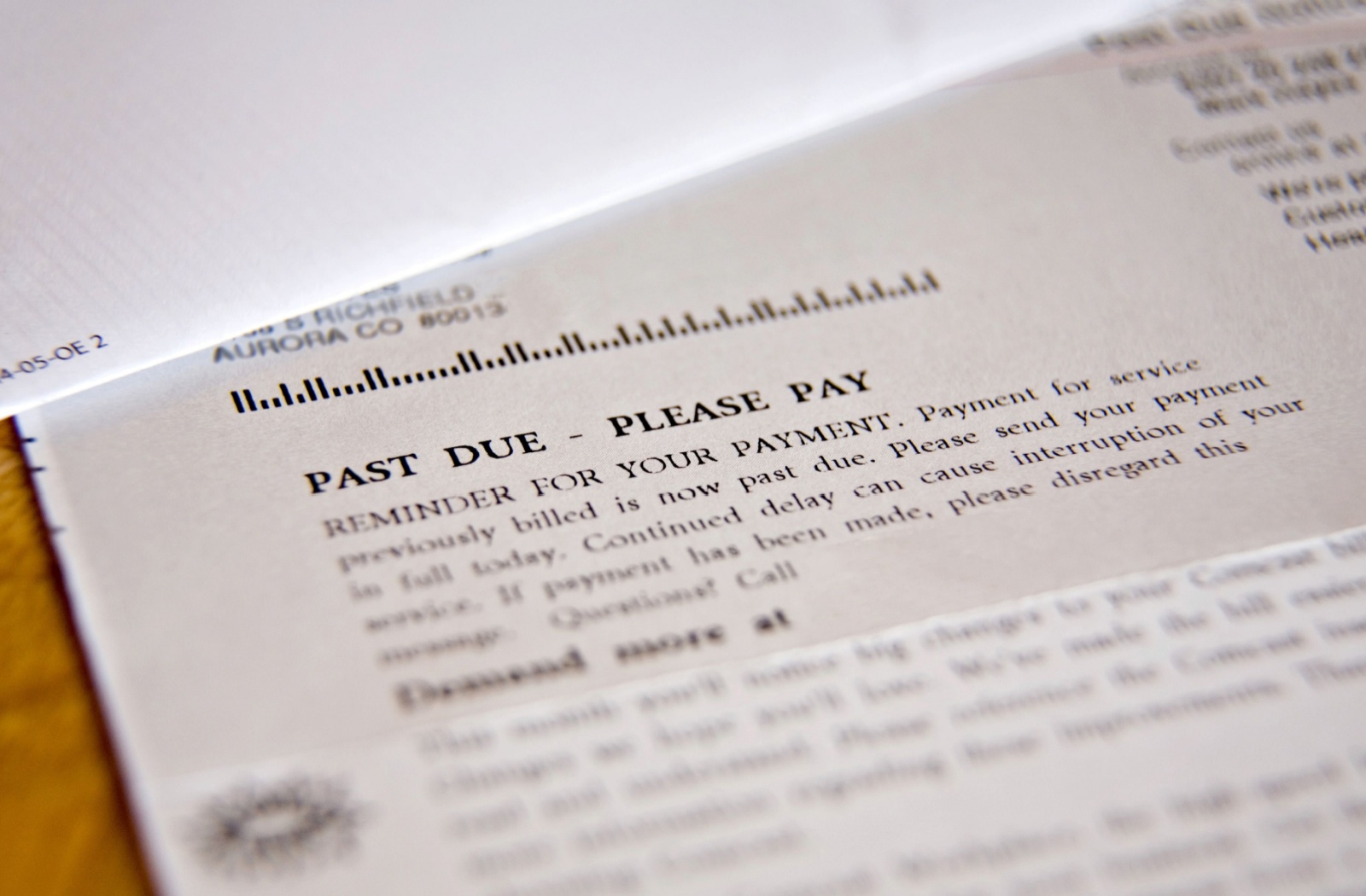 A close up of a letter showing a past due payment and looking for payment action.