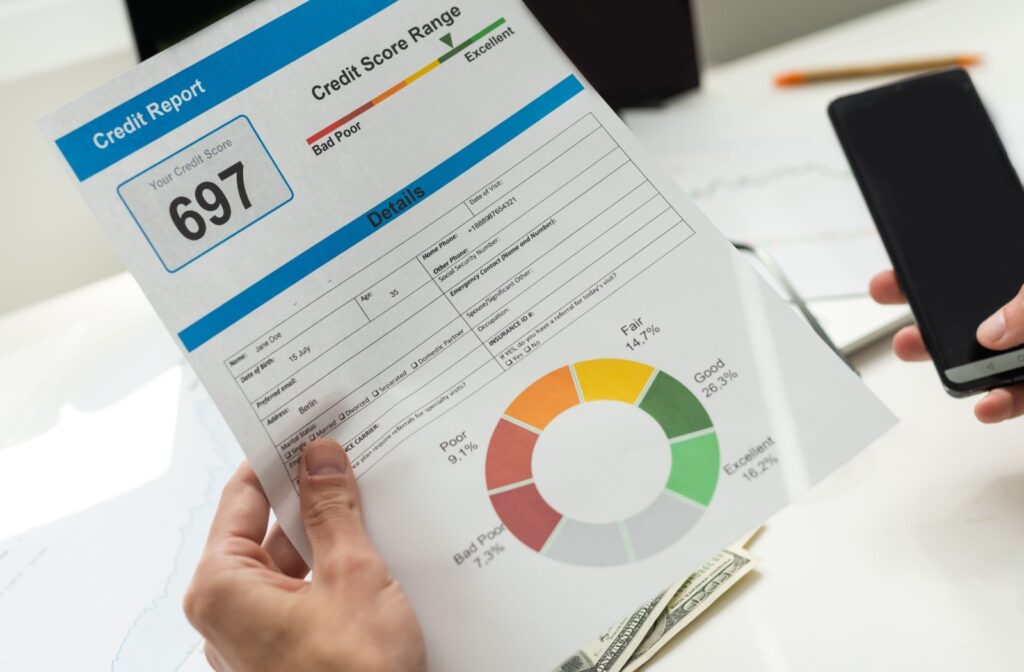 A hand holding a credit report.