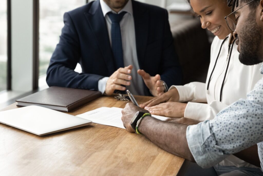 A credit counsellor helping a couple understand consolidated credit and credit score.